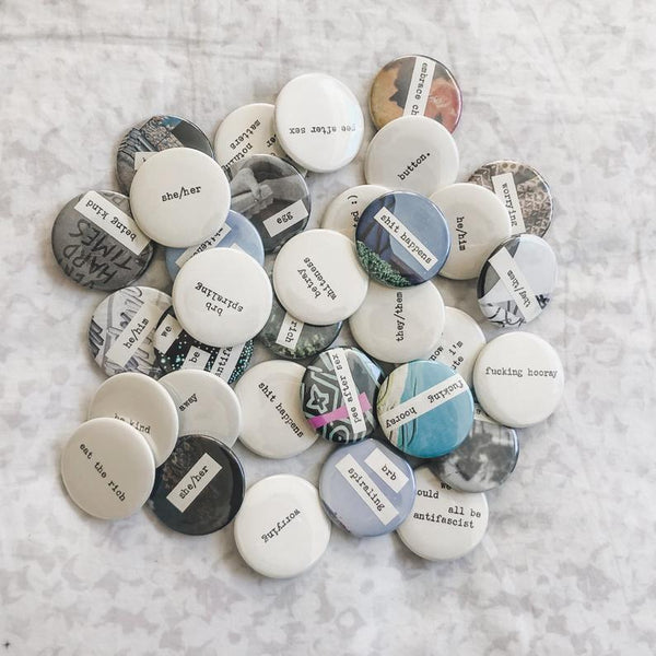 assortment of pinback buttons made with an antique typewriter